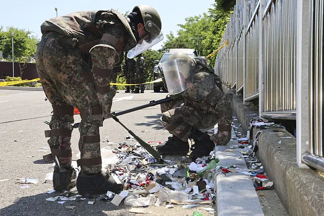 Dos soldados inspeccionan uno de los globos norcoreanos.IM SUN-SUKAP